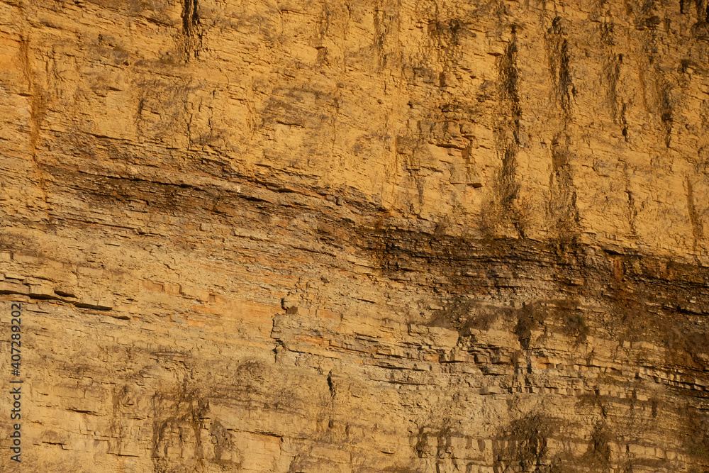 Naklejka premium Close up view from a yellow quarry with sandstone. Pattern. Perfect for Backgrounds.