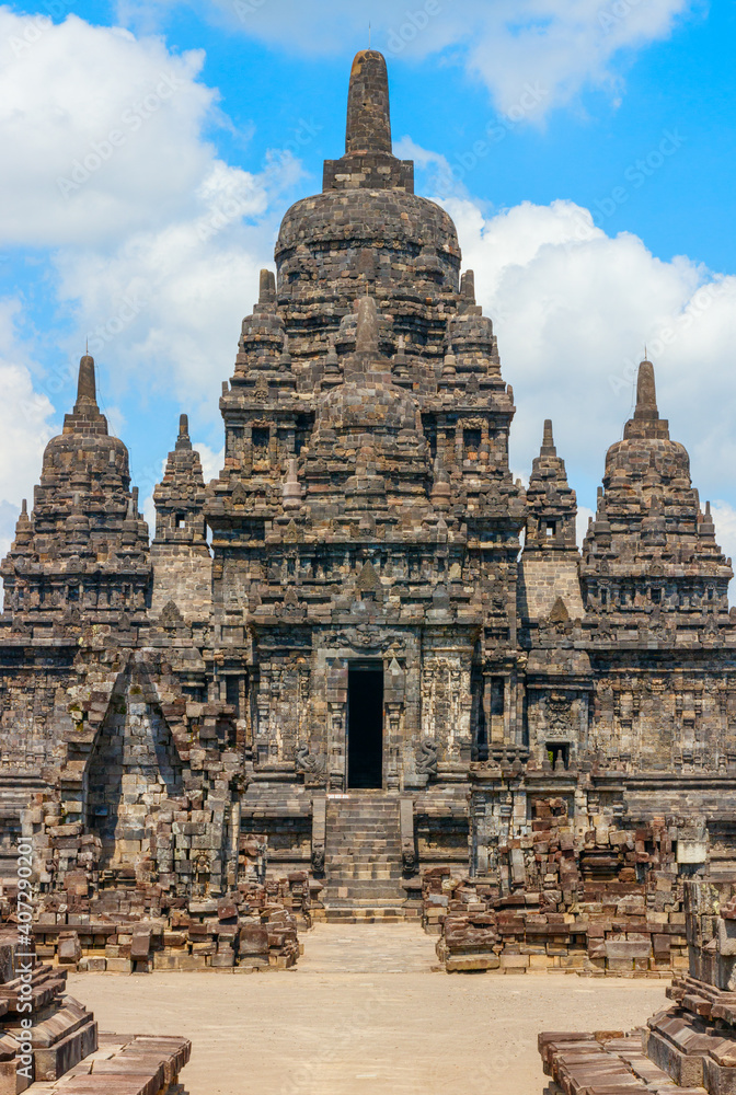 View of the Sewu temple complex under a blue sky with clouds. The Sewu temple is the second largest Buddhist temple of Indonesia and is located near the famous Prambanan temple. Java, Indonesia.