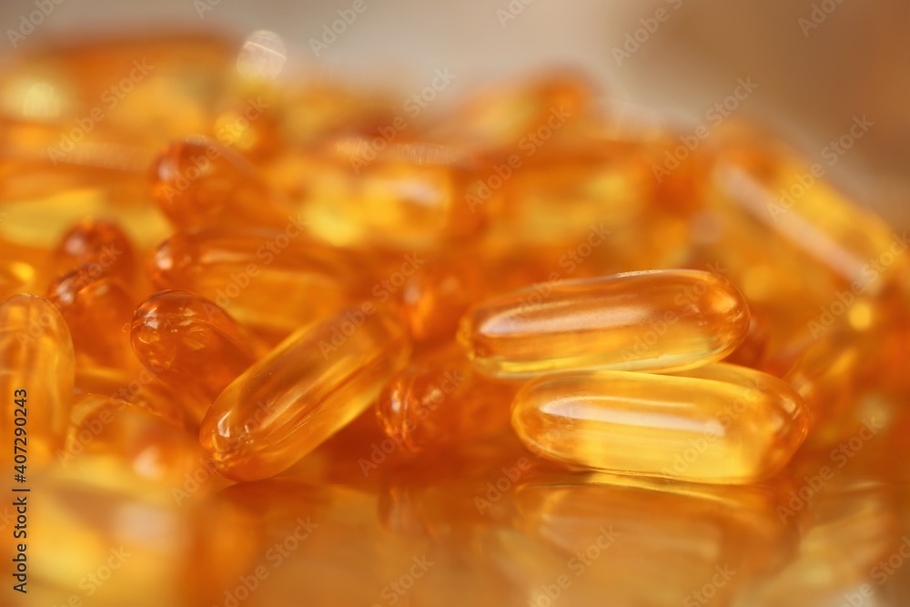 fish oil capsules close-up set on blurred gold background.Fish oil in gelatin capsules. Omega three.Supplements for a healthy diet. Healthy fats fish oil capsules close-up set on blurred gold background.Fish oil in gelatin capsules. Omega three.Supplements for a healthy diet. Healthy fats