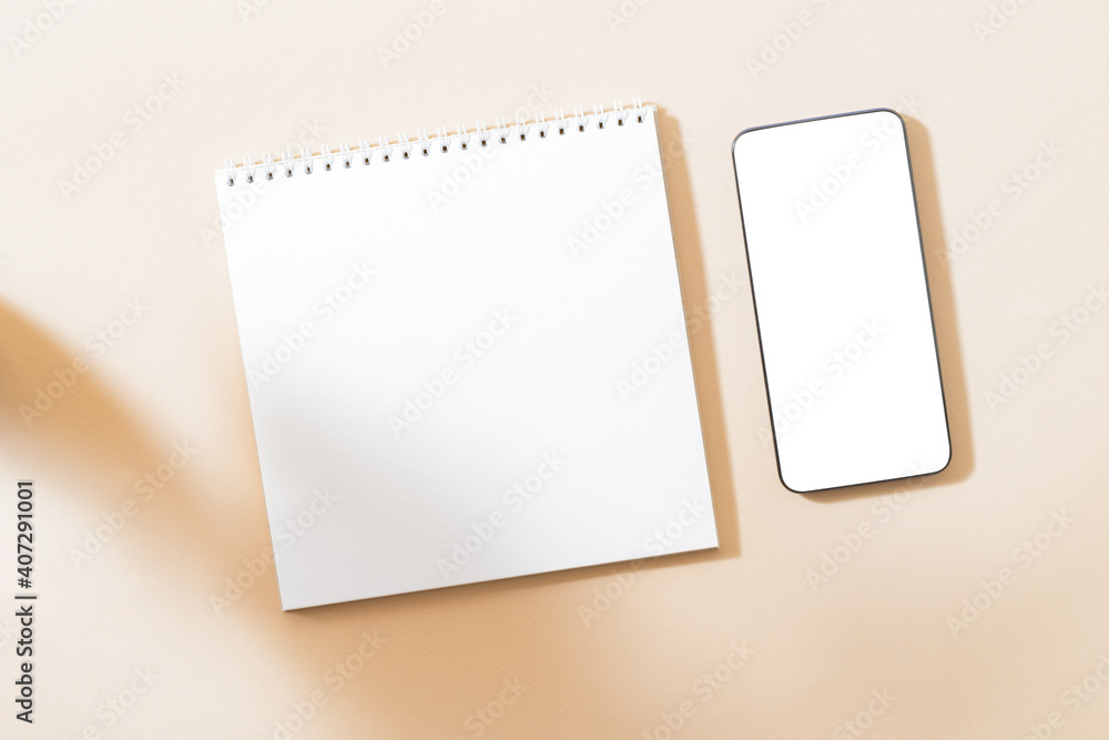 Flat Lay mockup of smartphone with blank screen, white notepad and contrasting shadows on color background Flat Lay mockup of smartphone with blank screen, white notepad and contrasting shadows on color background