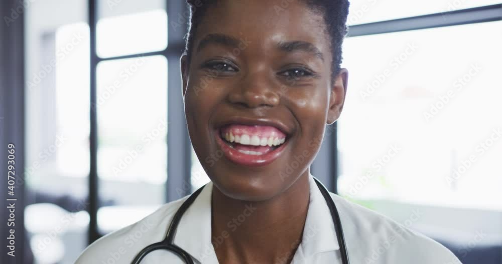 Portrait of african american female doctor looking at camera and smiling Portrait of african american female doctor looking at camera and smiling