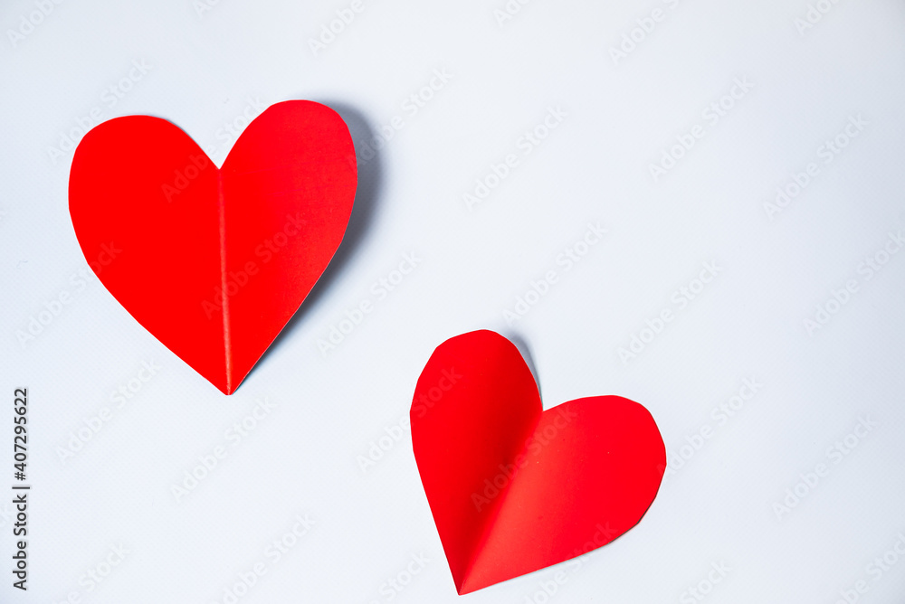Paper elements in shape of heart flying on white background. Symbols of love for Happy Women's, Mother's, Valentine's Day, birthday greeting card design.