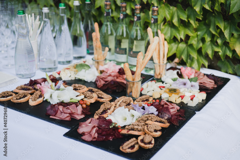 Catering banquet table at wedding reception. Restaurant presentation,  european cuisine, food consumption, party concept. Food styling, appetizers  bar, welcome drink, event design. Stock Photo | Adobe Stock