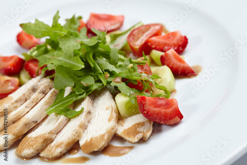 chicken fillet with salad and strawberries
