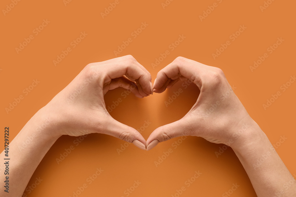 Fototapeta premium Hands making heart on color background