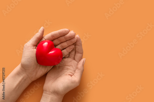 Hands with red heart on col...