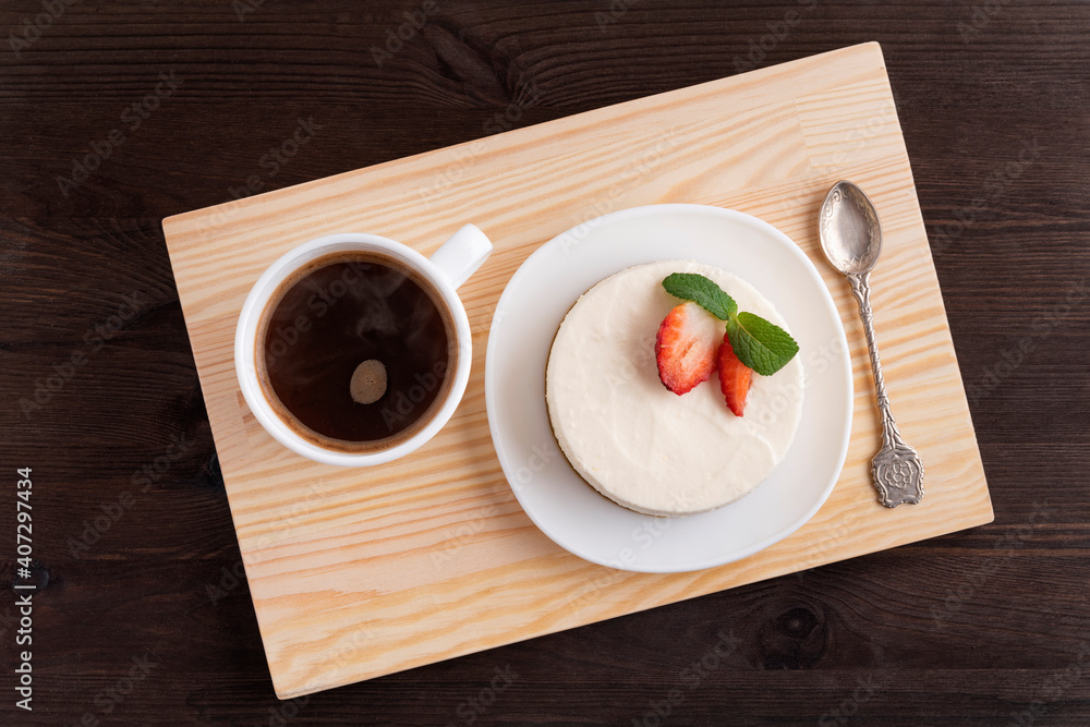 Cheesecake and cup of coffee on wooden tray. Nice breakfast. Top view Cheesecake and cup of coffee on wooden tray. Nice breakfast. Top view