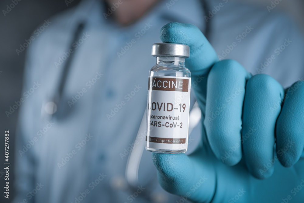 Doctor with a stethoscope on shoulder holding in hand COVID-19 , coronavirus, SARS-cov-2 vaccine. Healthcare And Medical concept.Development and creation vaccine Doctor with a stethoscope on shoulder holding in hand COVID-19 , coronavirus, SARS-cov-2 vaccine. Healthcare And Medical concept.Development and creation vaccine