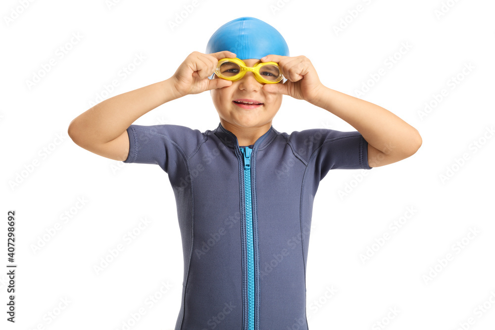 Boy in a wetsuit putting on swimming goggles Boy in a wetsuit putting on swimming goggles