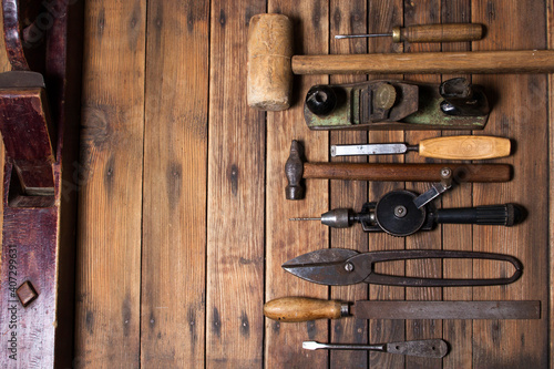 Old hand tools in a row background