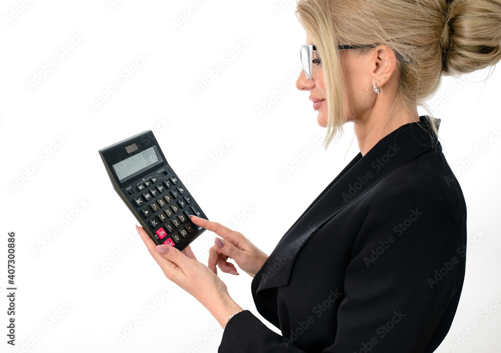 Businesswomanaccountant in a black suit clicks on a calculator to calculate tax financial expenses Businesswomanaccountant in a black suit clicks on a calculator to calculate tax financial expenses