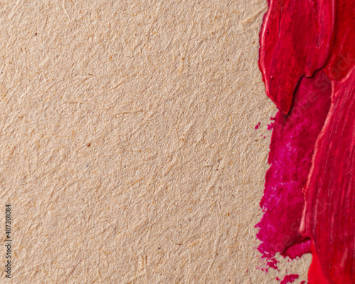 Close up Texture Red color paint on an old yellowed paper. Brush marks stroke for paper graphic design on background. Copy space for text.