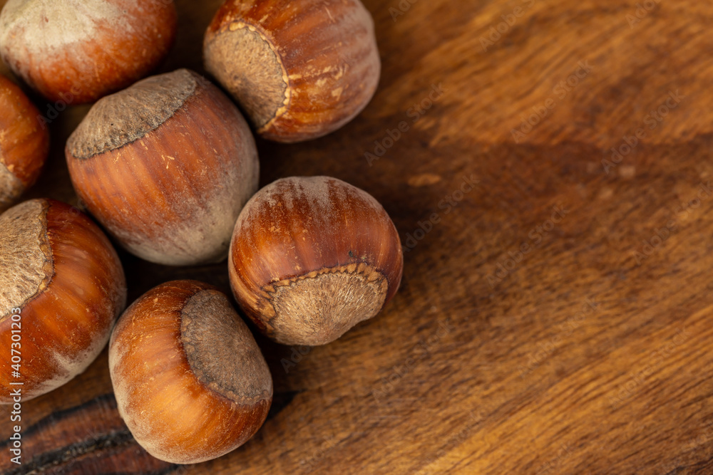composition of hazelnuts on a wooden board composition of hazelnuts on a wooden board