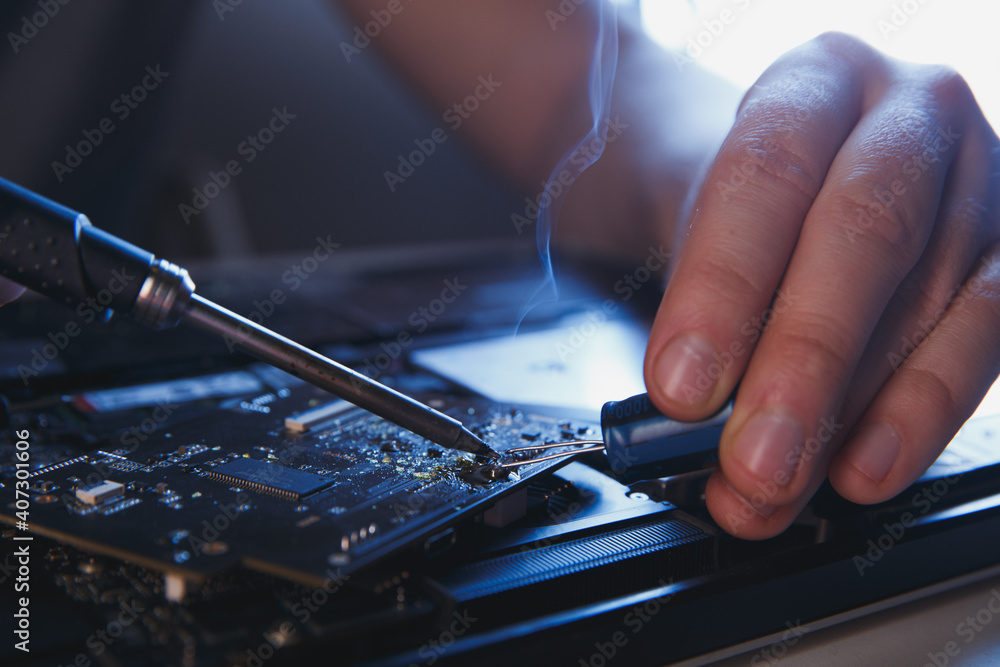 computer hardware engineering. technology science concept. developer soldering electronic component