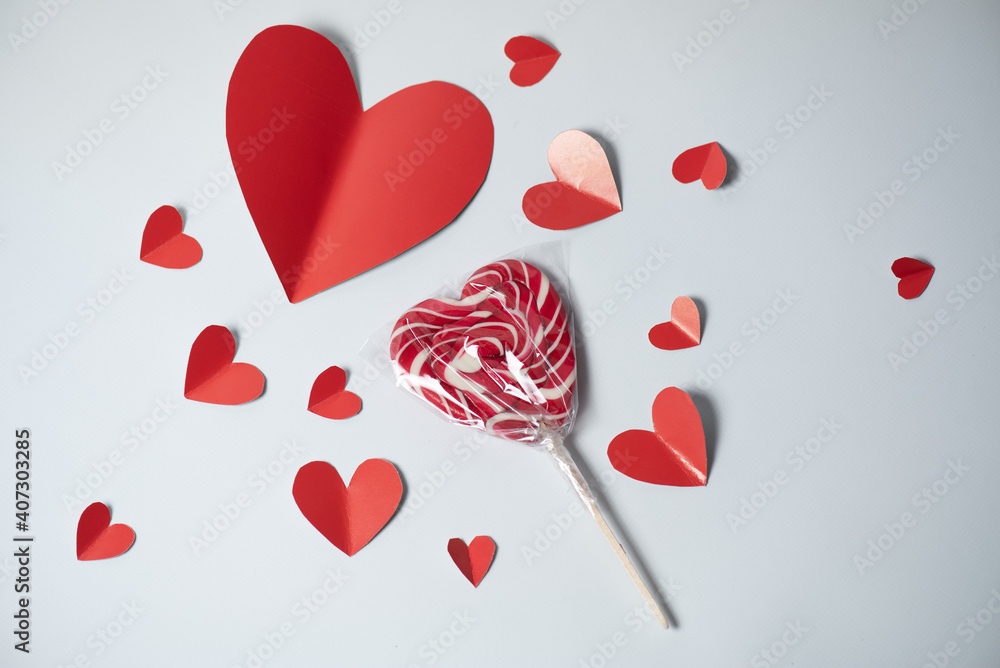 Valentine's Day background. red hearts and lollipop on white background. Valentines day concept. Flat lay, top view, copy space
