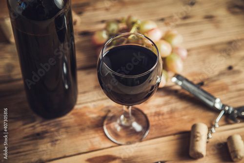 Bottle and glass of Red wine with grapes