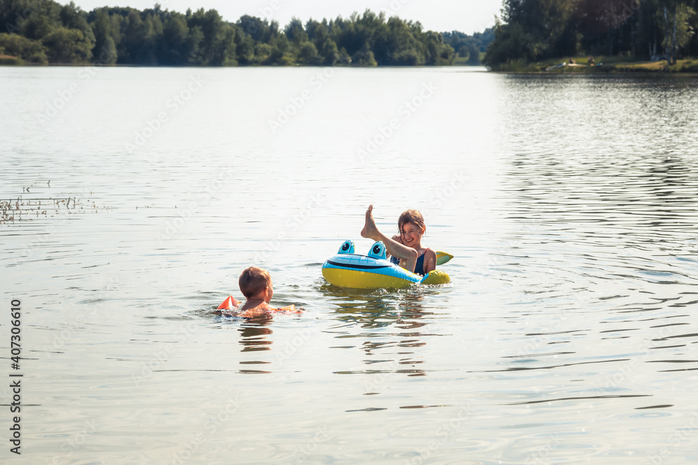 Happy children playing having fun and swimming in river concept happy childhood during summer holidays.