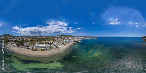 Aerial drone 360 Degree panoramic sphere aerial photo of the beautiful beach front of Ibiza in Spain showing the Spanish beach and hotels from above