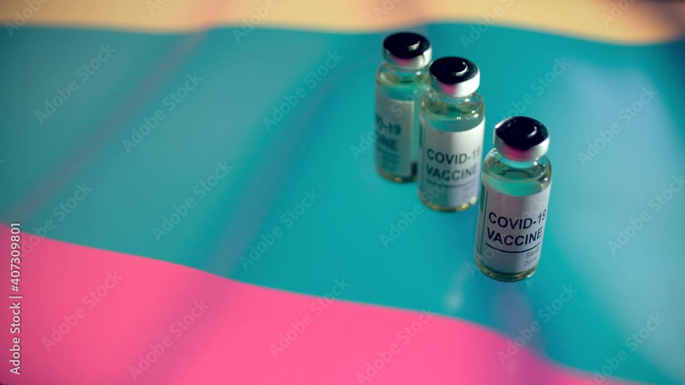 Bottles with COVID-19 vaccine and flag of Lithuania Bottles with COVID-19 vaccine and flag of Lithuania