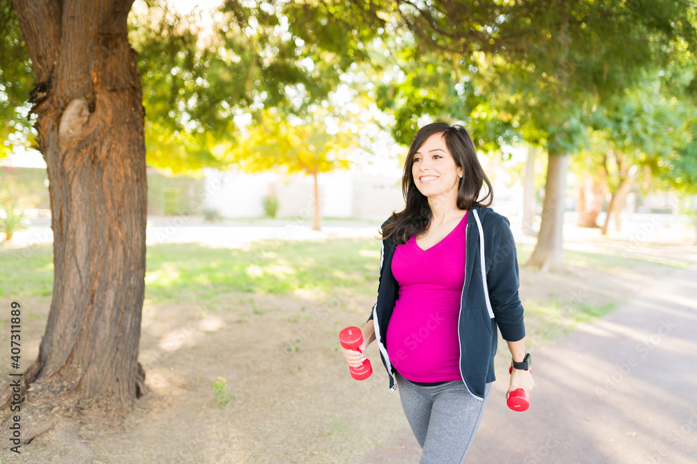 Active pregnant woman exercising in the park Active pregnant woman exercising in the park