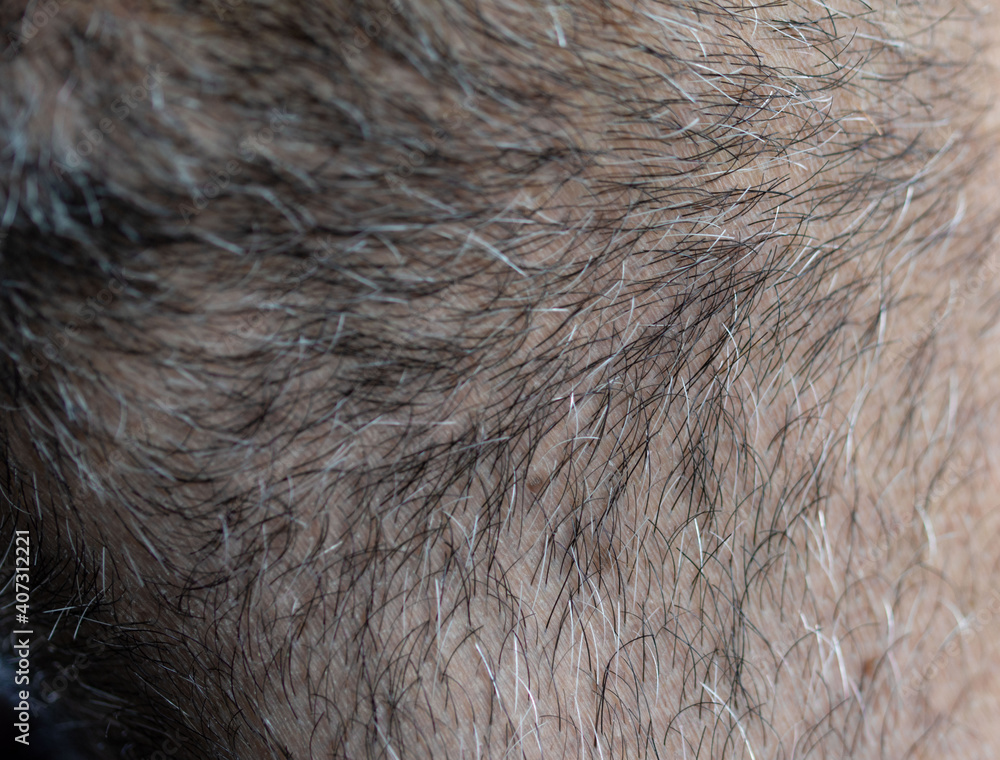 Close-up of an unshaven male face. Selective close-up macro photography with a blurry background Close-up of an unshaven male face. Selective close-up macro photography with a blurry background