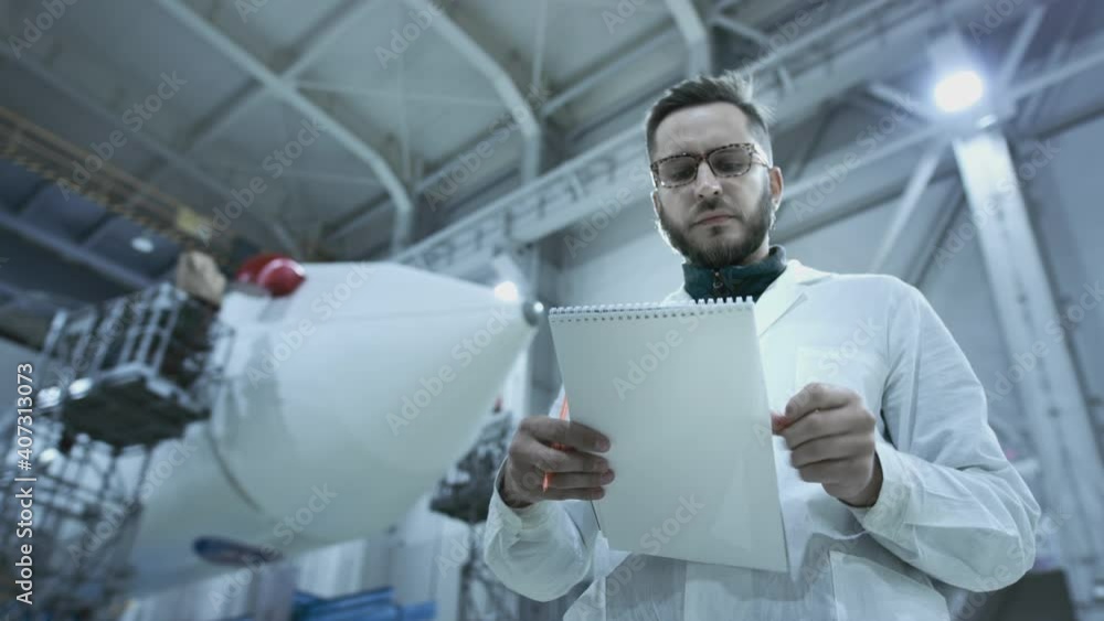 custom made wallpaper toronto digitalA scientist engineer inspects a spaceship, makes notes on a tablet. A space rocket in a military hangar being prepared for launch. Space technologies. Construction of Heavy Rocket. Humanity in Space