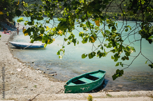 Green boat in lake Abrau near Novorossiysk city in Abrau Durso village, Russia photo