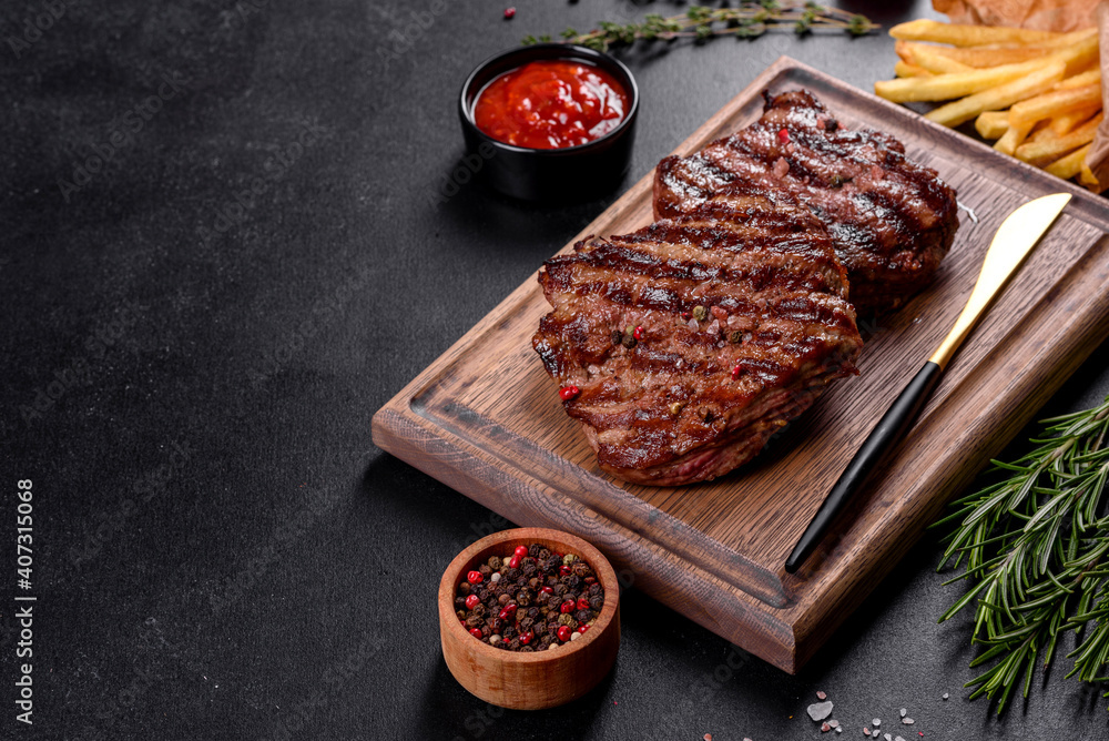 Fresh juicy delicious beef steak on a dark background Fresh juicy delicious beef steak on a dark background