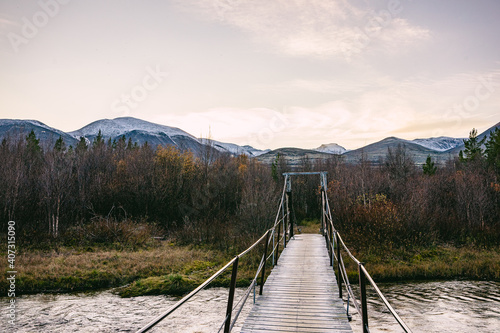 Bridge over a river with mountains in the background of rondane national park