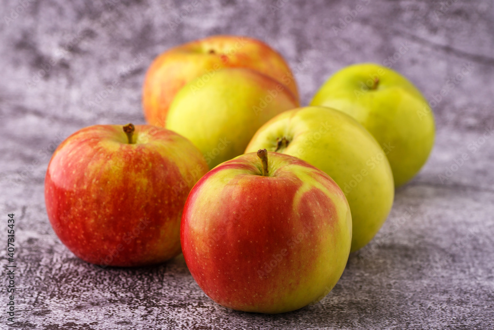 Green and red apples on blackboard or chalkboard background. Close-up on a gray background.Ideal food for diet. Green and red apples on blackboard or chalkboard background. Close-up on a gray background.Ideal food for diet.