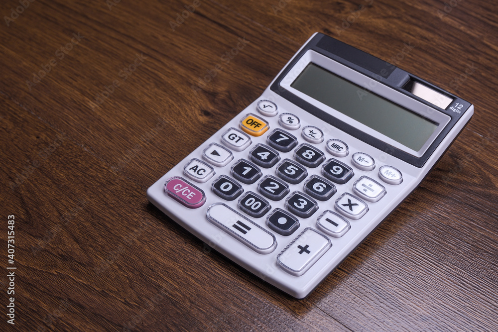 Calculator keypad on a wooden floor background. Top view. Copy space Calculator keypad on a wooden floor background. Top view. Copy space