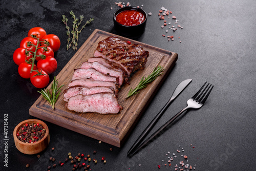 Fresh juicy delicious beef steak on a dark background