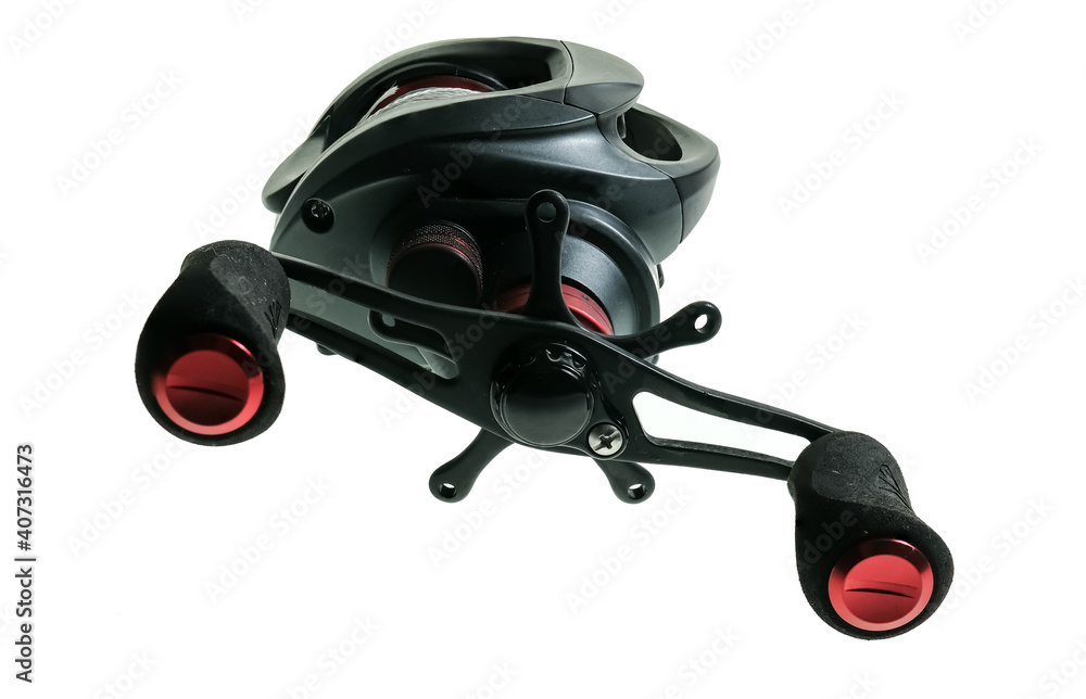 Close up of a black bait caster fishing reel spooled with braided mailing isolated on a plain white background Close up of a black bait caster fishing reel spooled with braided mailing isolated on a plain white background