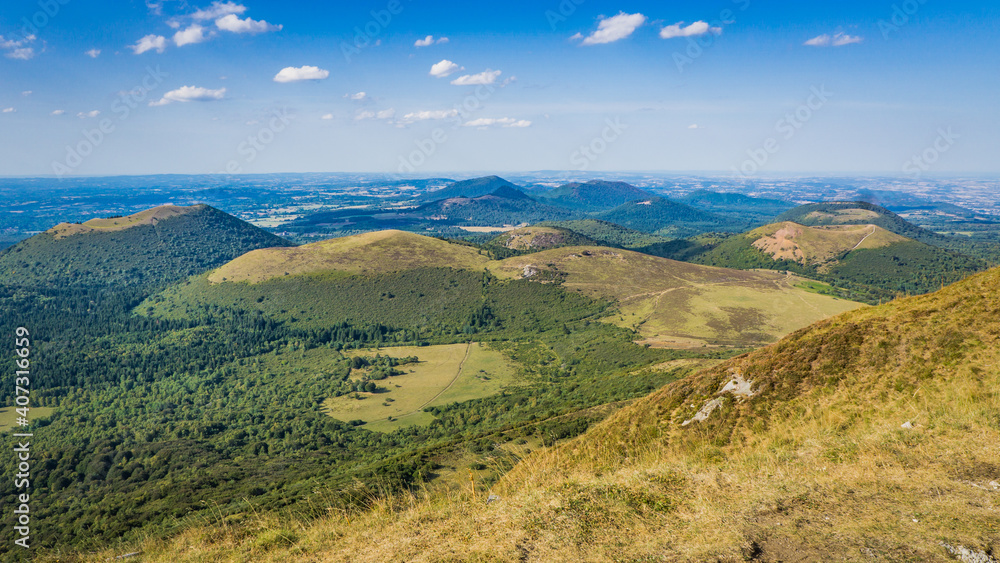 View on the Chaine des Puys volcanoes range from the top of the Puy de Dome, the most famous volcano this range, in Auvergne, France View on the Chaine des Puys volcanoes range from the top of the Puy de Dome, the most famous volcano this range, in Auvergne, France