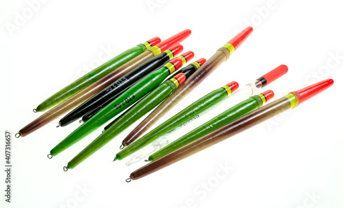 Close up of a selection of various fishing floats and bobbers isolated on a plain white background