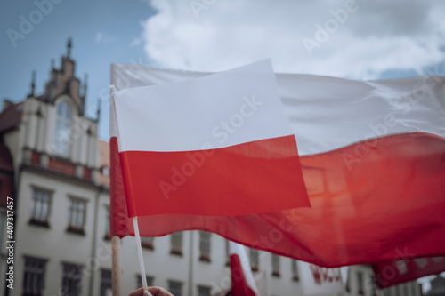The Polish flag waving in the wind against the sky