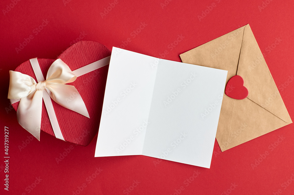 Valentines day card mockup with envelope and heart gift box on red paper background Valentines day card mockup with envelope and heart gift box on red paper background