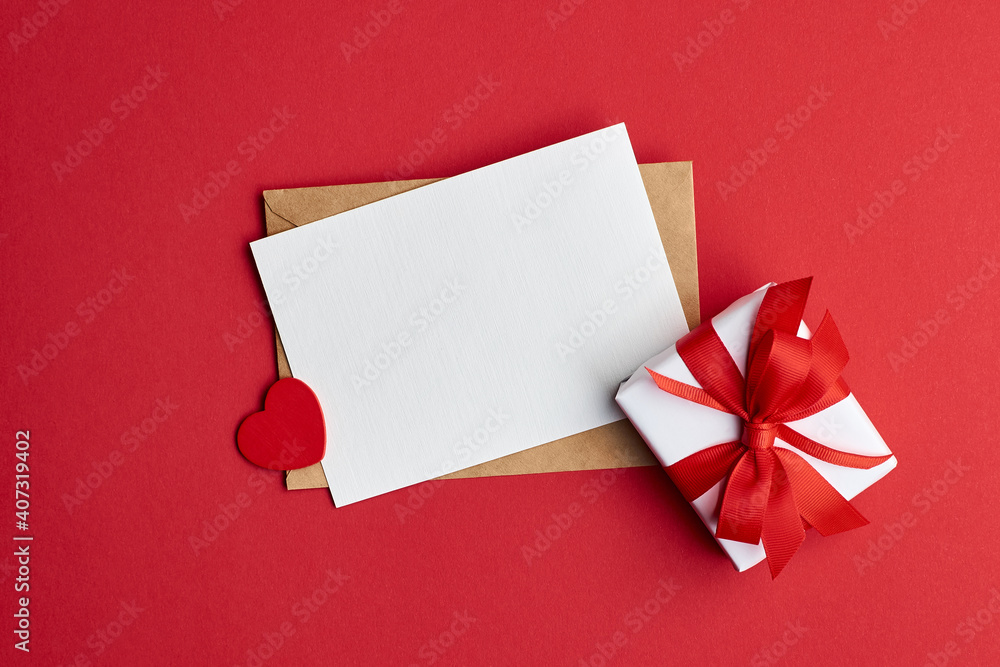 Valentines day card mockup with envelope and gift box with heart on red paper background Valentines day card mockup with envelope and gift box with heart on red paper background