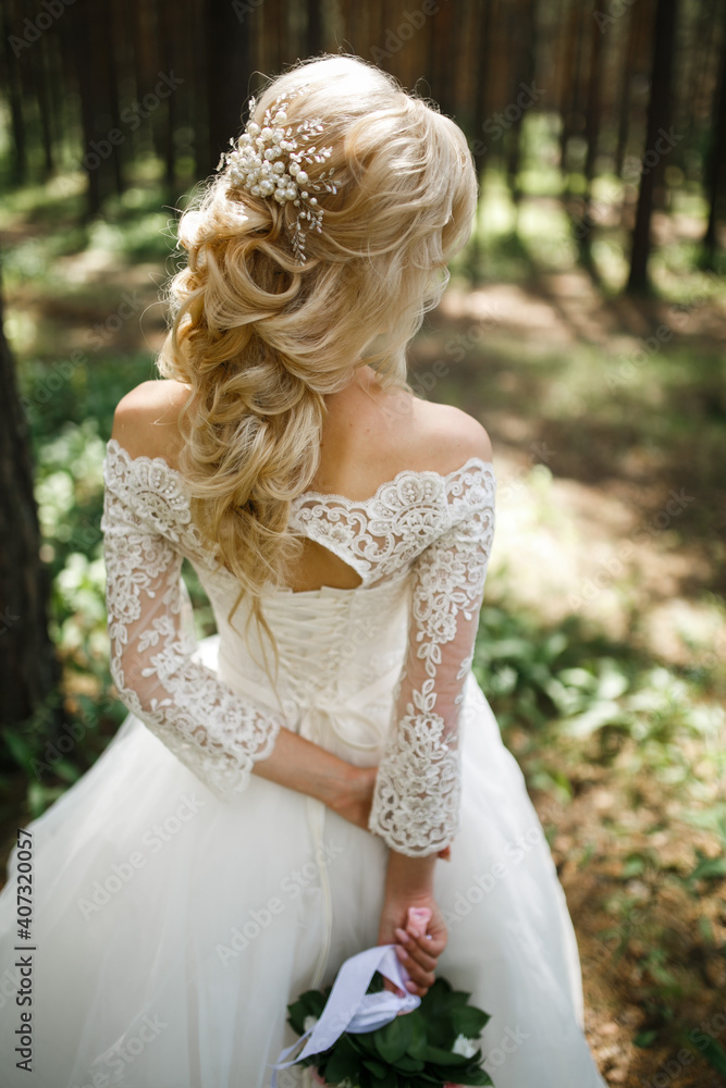 Bride's hairstyle back view. Bride in nature, back view.
