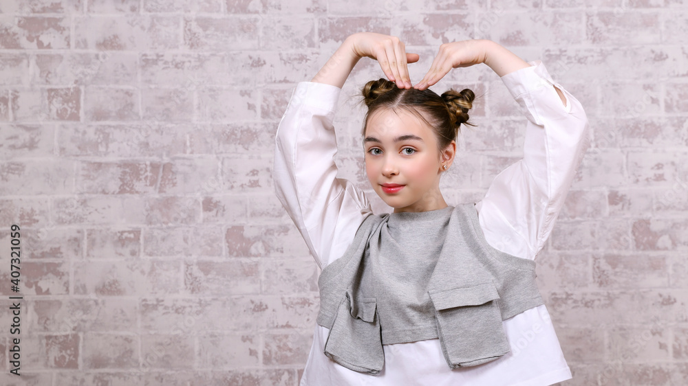cute girl with a smile and a heart out of hand gesture cute girl with a smile and a heart out of hand gesture