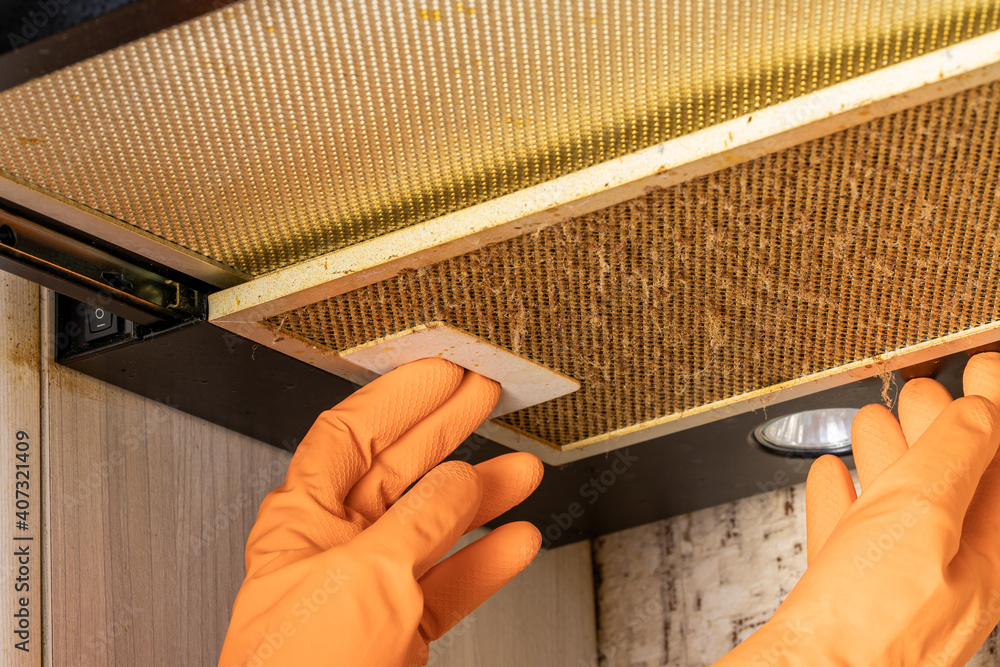 cleaning and washing dirty cooker hood filter. fat and dust at filter.  domestic kitchen Stock Photo | Adobe Stock