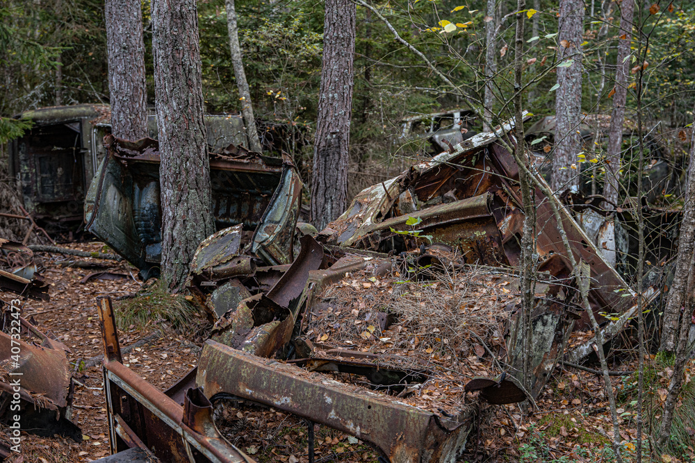 Old cars in wild nature on the car cemetery of Kyrkö Mossei in Sweden Old cars in wild nature on the car cemetery of Kyrkö Mossei in Sweden