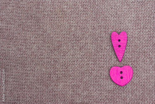 Multicolored hearts on the background of a knitted product