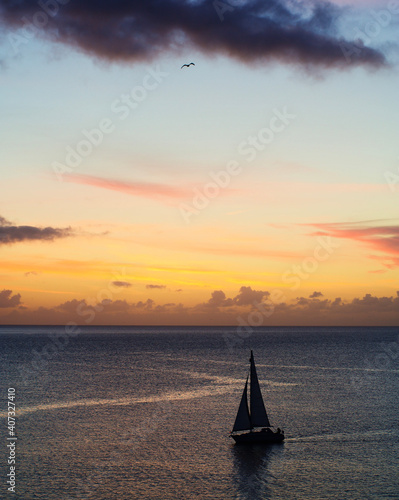 Sunrise over the sea in Falmouth Cornwall with Yacht and seagull 