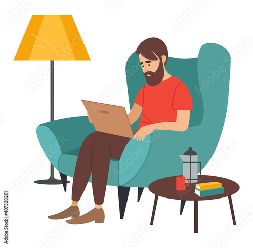 Bearded man sitting on the armchair near coffee table in room and correspondence surfing the Internet. Male character communicating through network on the laptop. Freelance, work from home concept