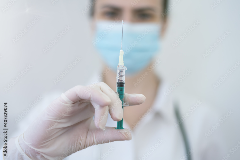 COVID-19 vaccine in researcher hands, female doctor holds syringe with vaccine for coronavirus cure. Concept of corona virus treatment, injection, shot and clinical trial during pandemic. COVID-19 vaccine in researcher hands, female doctor holds syringe with vaccine for coronavirus cure. Concept of corona virus treatment, injection, shot and clinical trial during pandemic.