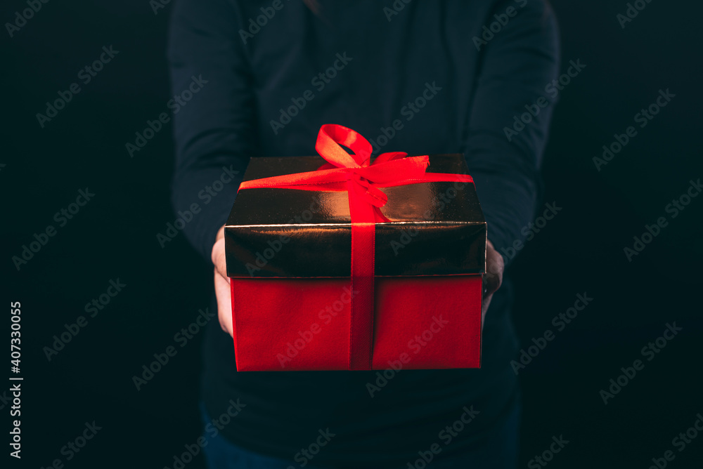 Close up photo of female hands holding red gift box. Close up photo of female hands holding red gift box.