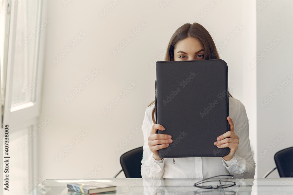 Girl in a office. Woman in a white shirt. Lady use the laptop. Girl in a office. Woman in a white shirt. Lady use the laptop.