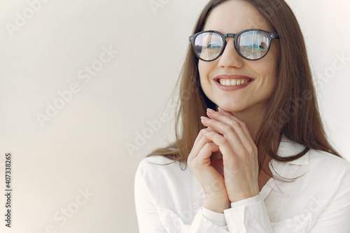 Girl in a office. Woman in a white shirt. Lady in a glasses.