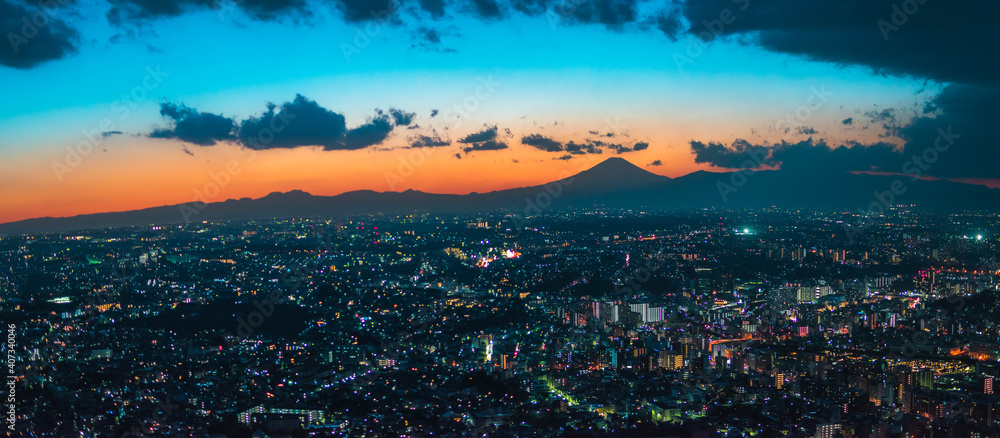 Sunset behind Mt Fuji in Yokohama Japan with Tokyo city below at night